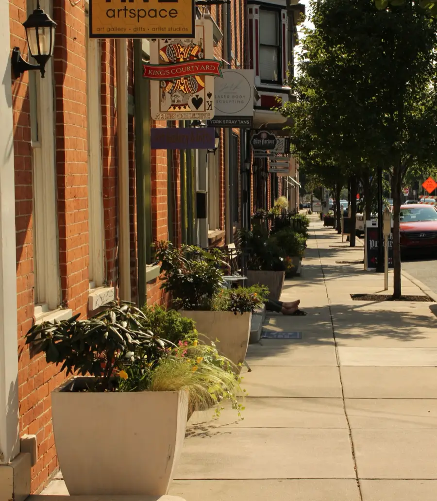 Brick storefronts and planters along a small-town main street