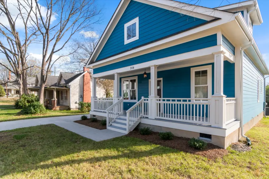 Blue craftsman-style home with a white front porch