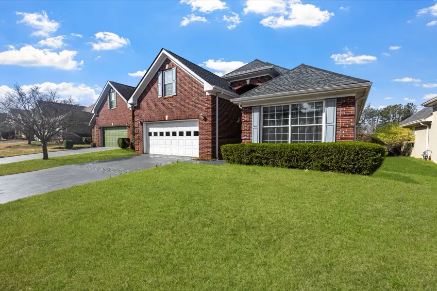 Red brick split-level with a bay window and attached garage