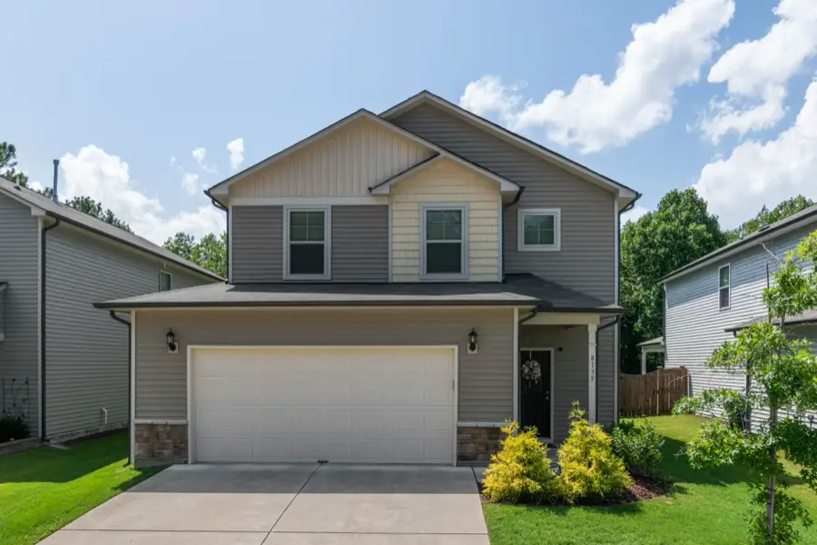 Two-story home with stone accents and a two-car garage