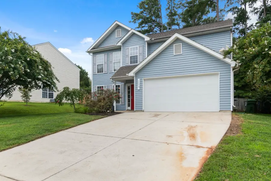 Light blue two-story home with a front-facing garage