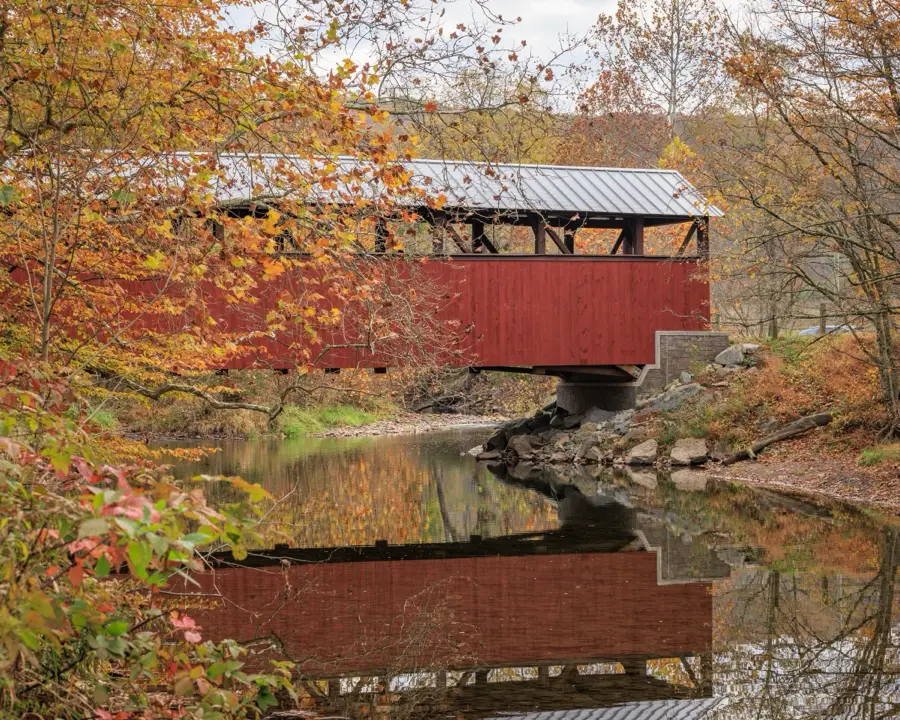 Covered bridge over a creek in autumn